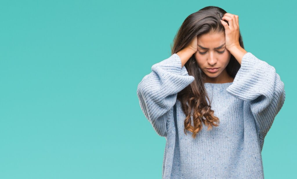 Woman looking irritable and uncomfortable due to perimenopause in Eugene, OR